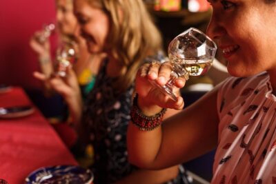 Tasting glasses raised at a distillery bar